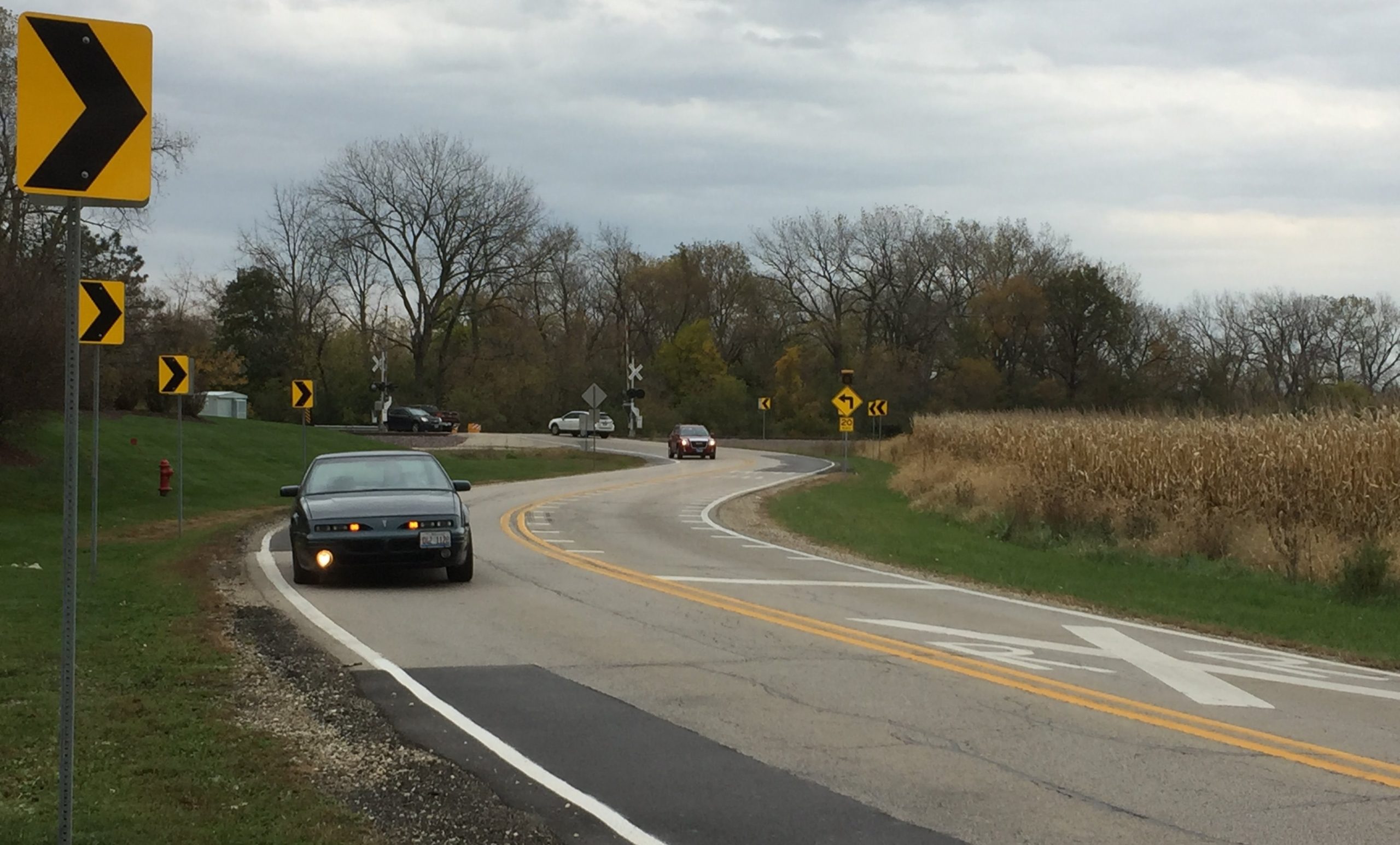 Cars heading east on Kreutzer Road from Route 47 slow to take a Le Mans-like double curve before reaching a railroad cross and small bridge over a creek. The village board will considering applying for a state grant to help pay for a project that would straighten the roadway.