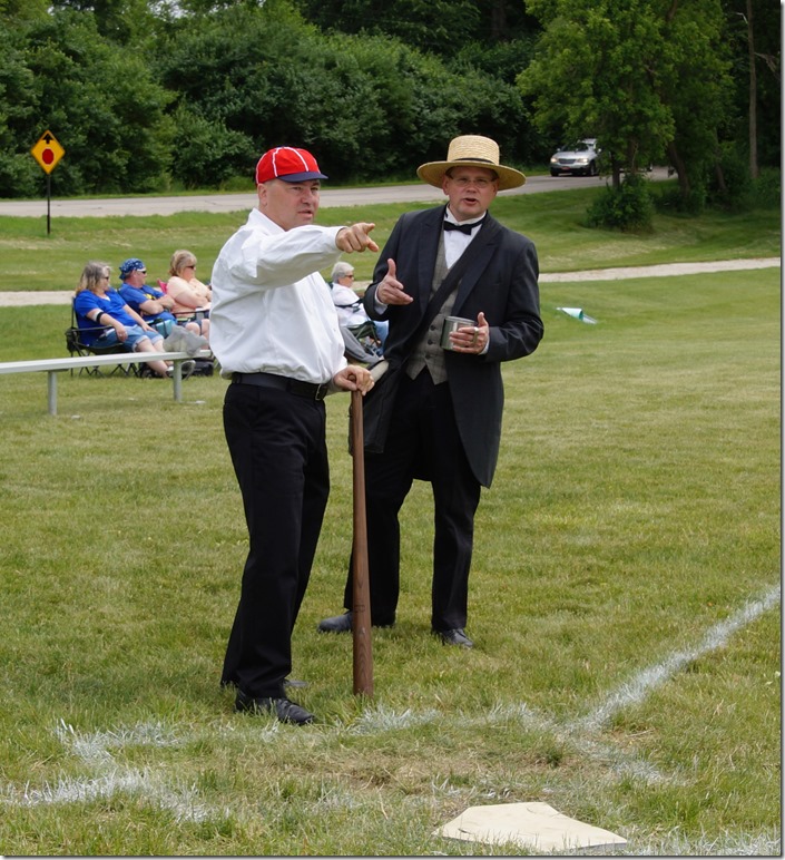 Paul Skowronski of Woodstock, with his replica bat, chats with barrister Dave Oberg. Kurt Begalka likens swinging the heavy wooden bat to ‘swinging a 2x4.’