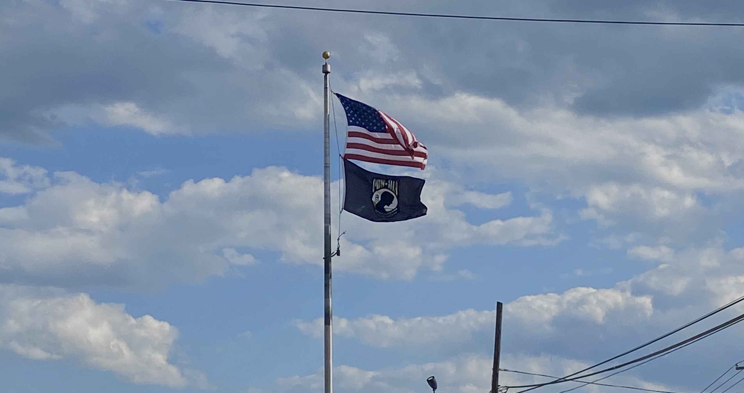 An American Flag and POW/MIA flag hang high in acknowledgment of current soldiers and veterans.