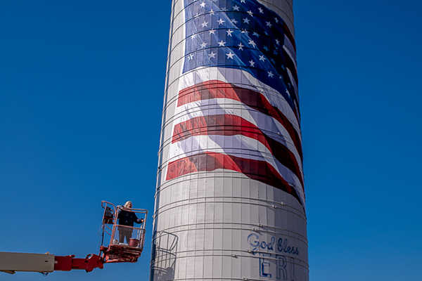 Local artist Lexi Mangieri works on her American Flag mural on a silo in Huntley.
