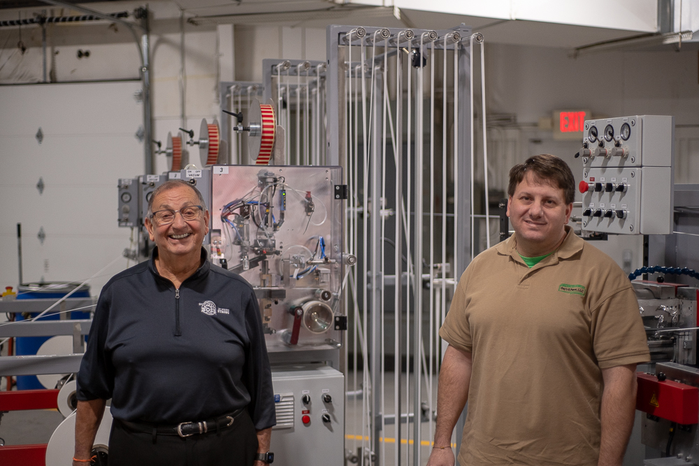 Guy Spinelli (left) with son Andy Spinelli at Boss Straw, which is located inside Spinelli’s Woodstock paper manufacturing company Guy’s E Paper LLC.