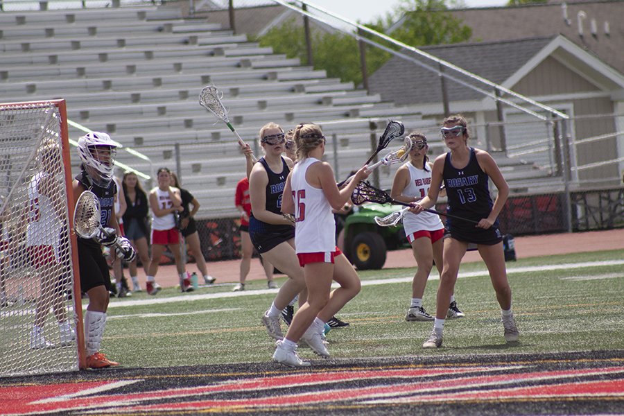 Huntley senior lacrosse player Kyleigh Higgins leads the charge in the Red Raiders' match with Rosary May 14.