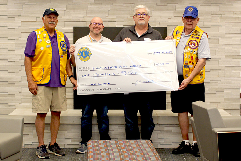 Huntley Area Lions Club members Jim Saletta (Far Left) and Jim Graves (Far Right) presented the HAPL with a $1,000 donation in honor of Helen Keller