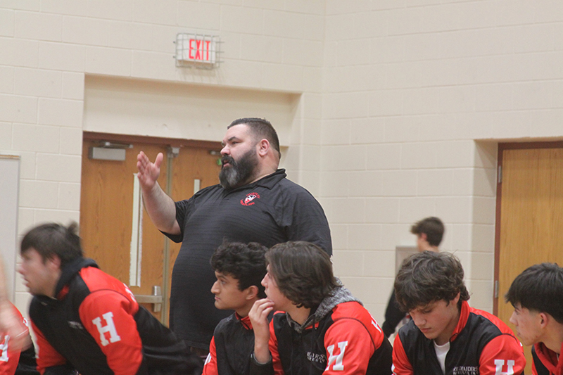 Huntley wrestling coach BJ Bertelsman gives encouragement during a match.