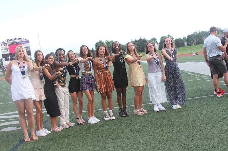 Huntley High School girls track and field Class 3A State Champion members show championship rings they received.