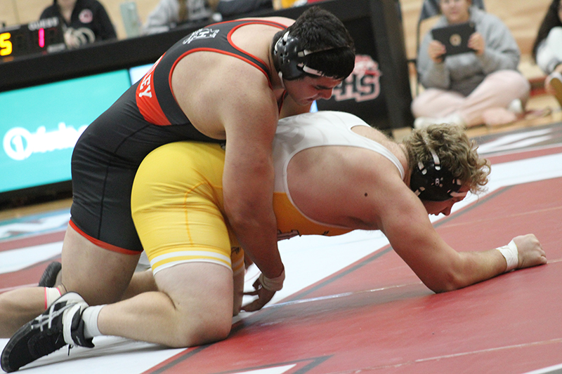 Huntley wrestler Markos Mihalopoulos, top, wins his 285 pound bout against Jacobs Dec. 7. The Red Raiders won, 45-22.
