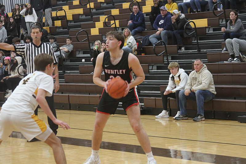 Huntley senior Ethan Blackmore (23) looks for an open teammate against Jacobs.