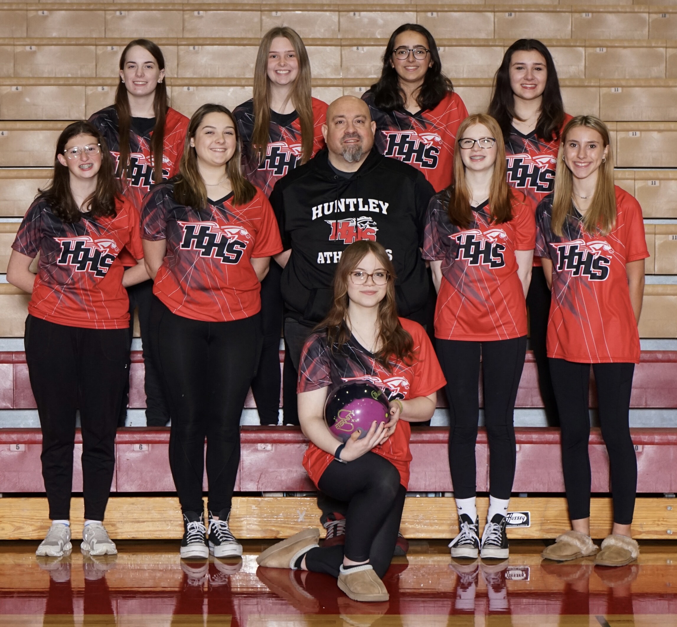 The Huntley girls bowling team for 2023-24, front, Erica DeBello. Middle row, from left, Isabella Kurash, Kaelyn Keegan, coach Eric DeBello, Mackenzie Miller and Ashlyn Tenglin. Back row from left:, Tara Wise, Jana Boudreau, Prianca Waters and Katie Scaletta.