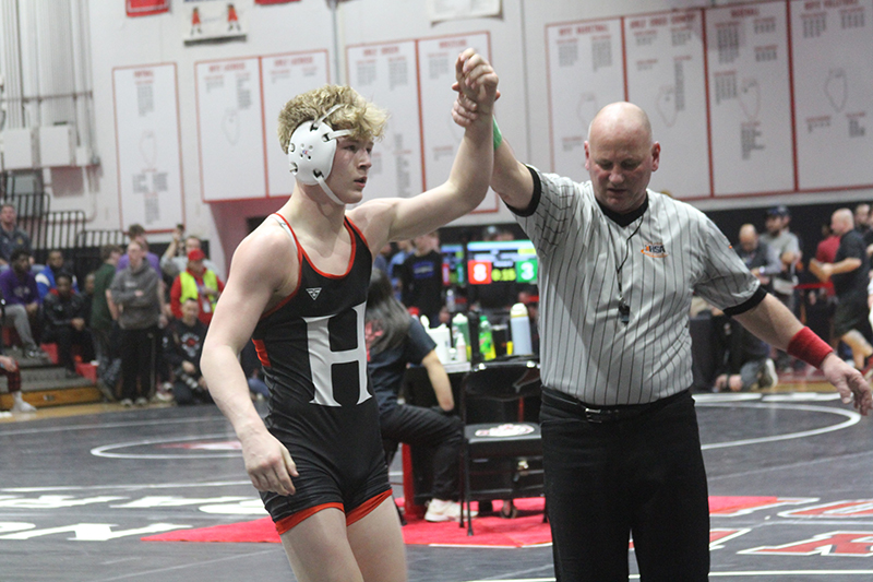 Huntley freshman Radic Dvorak has an arm raised in victory at the IHSA Class 3A Barrington Sectional Feb. 10. Dvorak finished fourth at 157 pounds to qualify for the state individual boys wrestling meet.