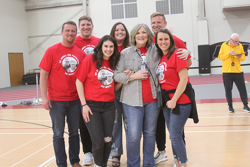 Huntley High School hosted an end-of-the-indoor season track meet in honor of the late HHS assistant track and field and football coach Joel Popenfoose March 15. Family members are front row from left: Victoria, Kim Doyle-Popenfoose and Kelsey. Back row: Adam, Marcus, Myra and Casey.