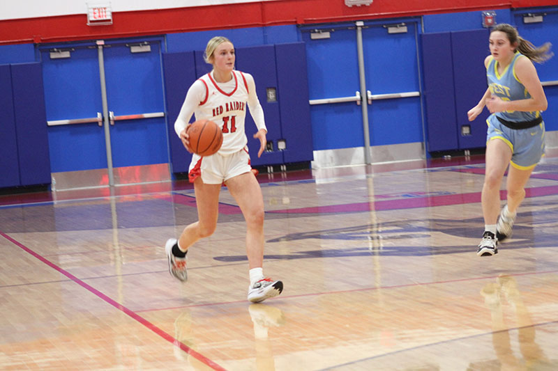 Huntley junior Anna Campanelli brings the ball up-court in a game at Dundee-Crown.