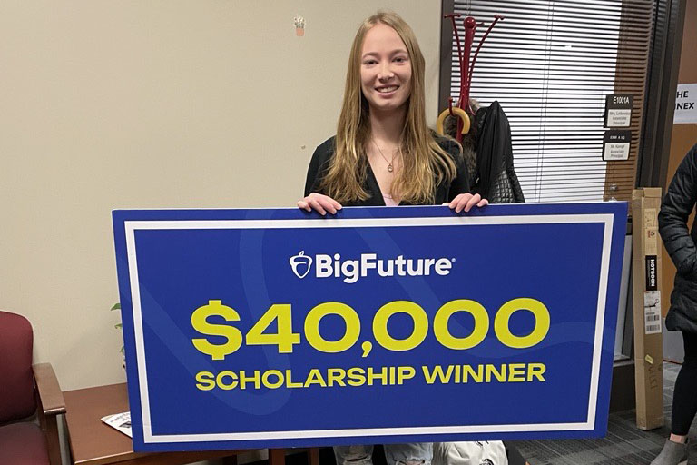Kylie Kachan, a junior at Huntley High School, accepted a ceremonial $40,000 scholarship check from College Board.