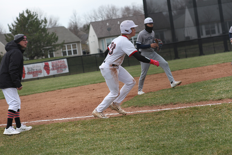 Huntley's Kyle Larson takes a lead off third base as head coach Andy Jakubowski looks on.