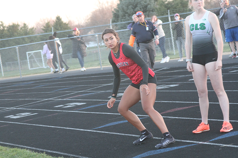 Huntley senior Sophie Amin concentrates before receiving the baton in the 4x400-meter relay April 8 at Crystal Lake South.