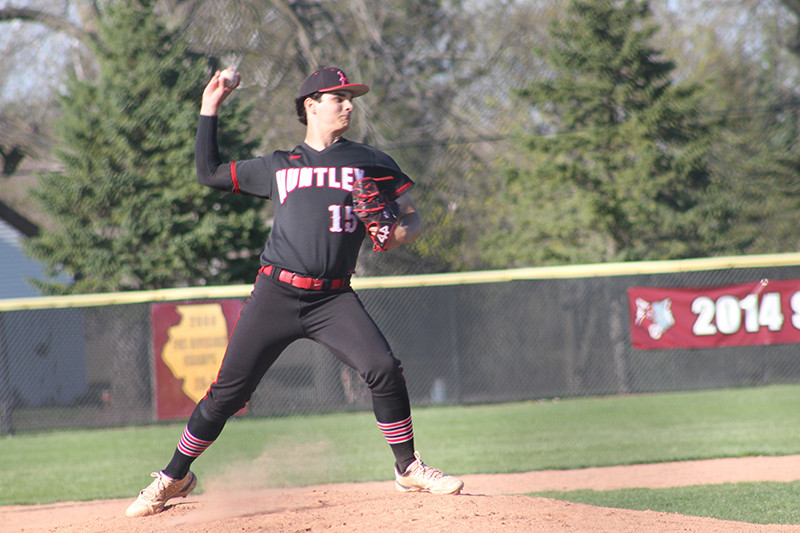 Huntley junior pitcher Mason Leske throws to first base to try and pick off a Prairie Ridge base runner.