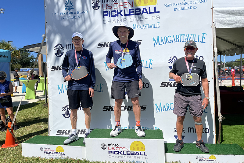 Sun City Huntley resident John Schwan, center, was presented with the gold medal he won at the US Open Pickleball Championships in Naples, Florida April 14.