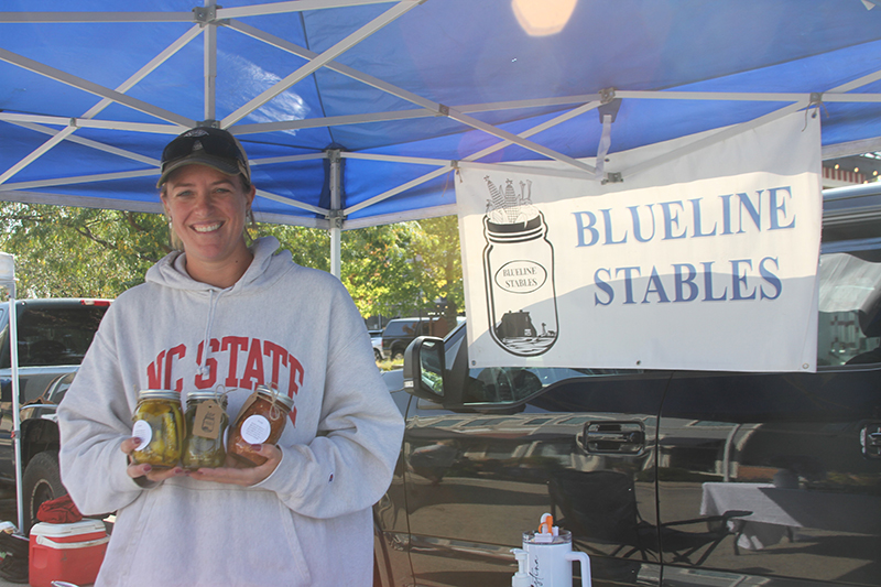Kristina Jedlink, owner of Blue Line Stables, shows some of her canned products available at Huntley Farmers Market on Saturdays at Huntley Town Square.